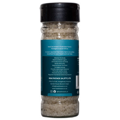 Side of a 100g HealthStack celtic salt glass bottle with recyclable plastic flip top lid, showing potential health benefits and company details.